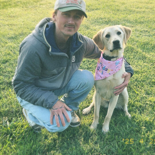 photo of caleb mcreynolds and his yellow labrador Xena